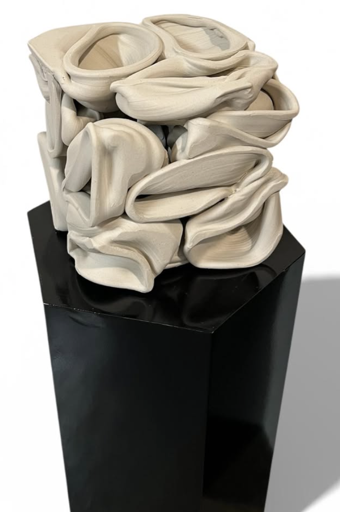 Folded ceramic sculpture on black base
